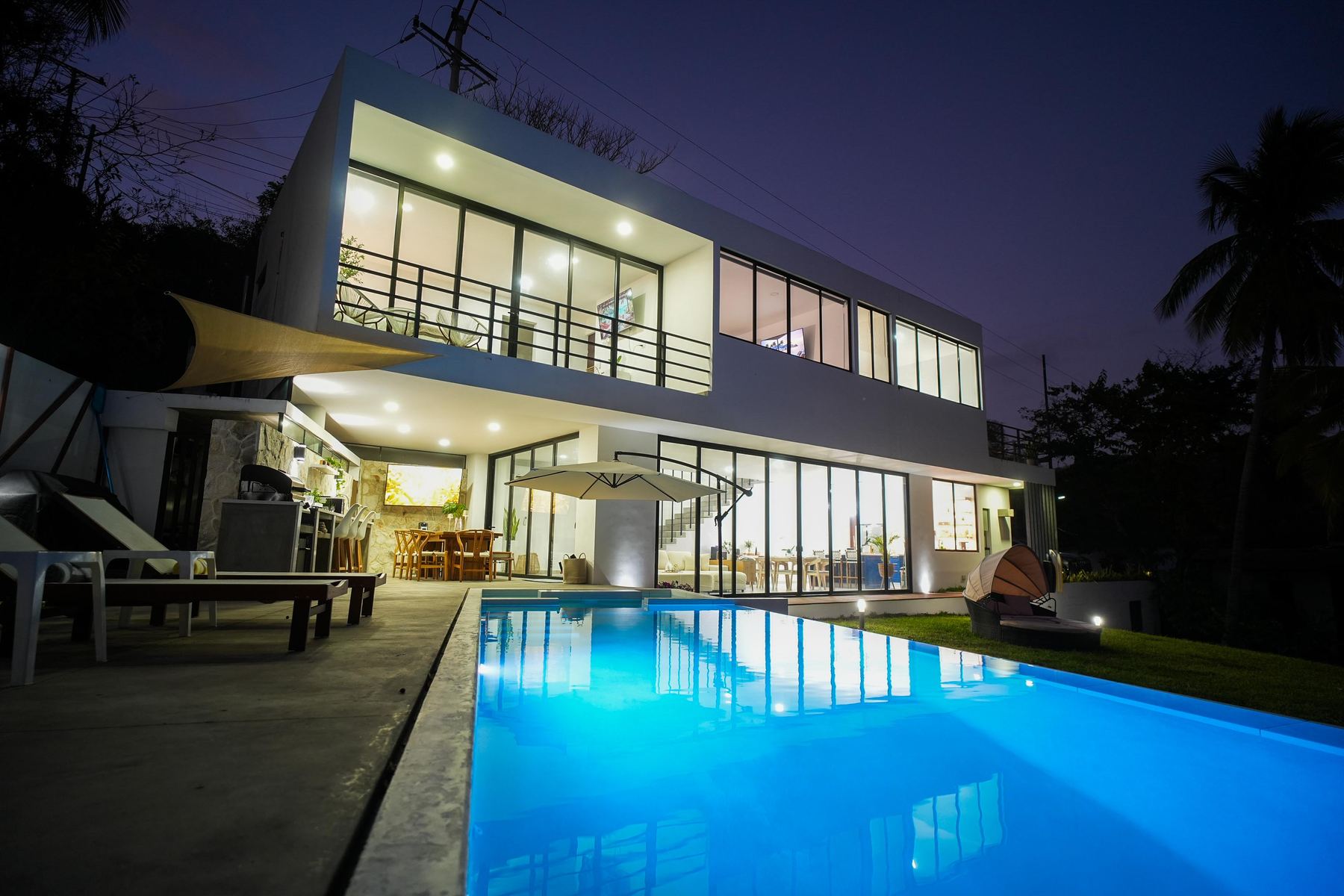 The villa glowing at dusk