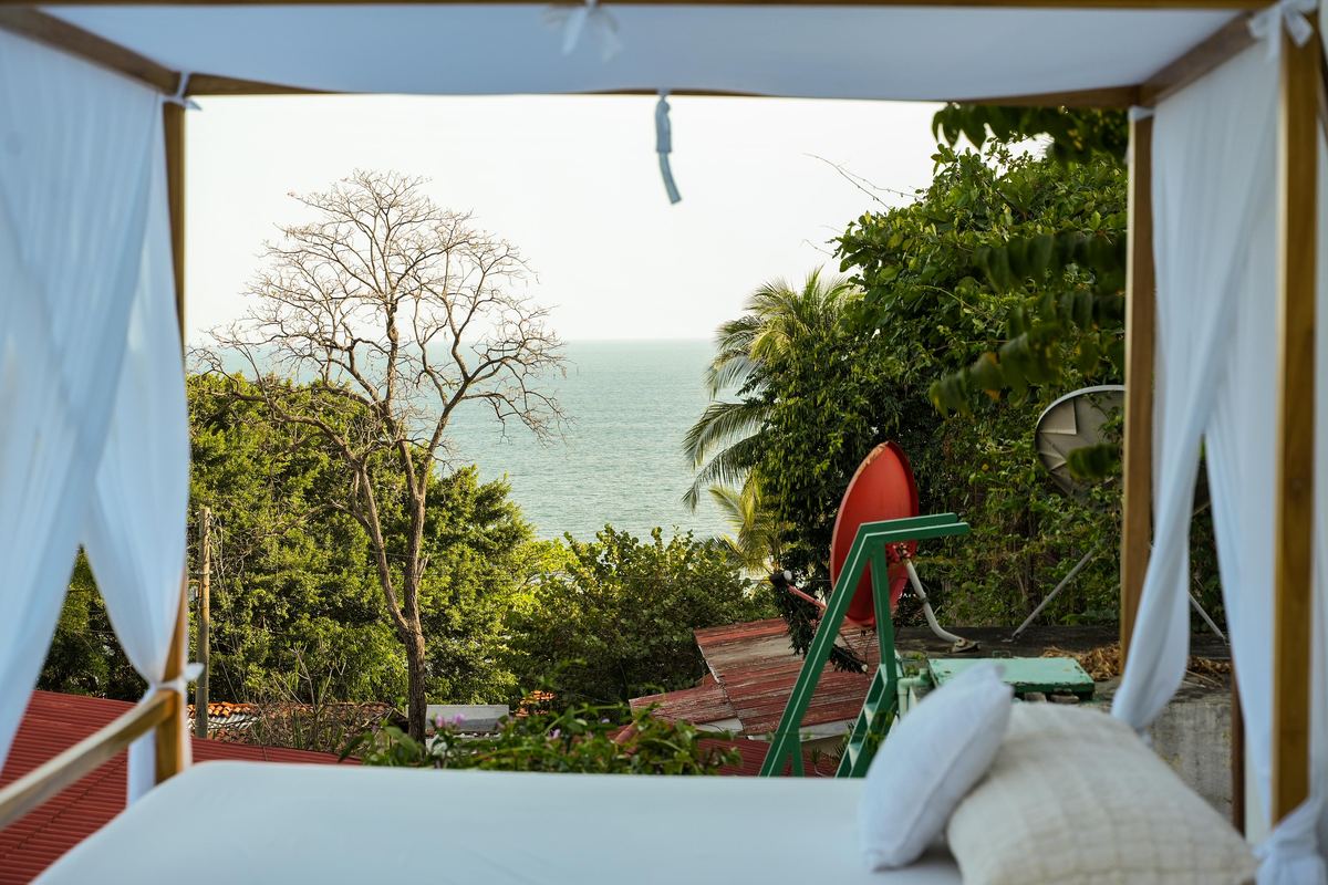 Canopy daybed overlooking the ocean at sunrise