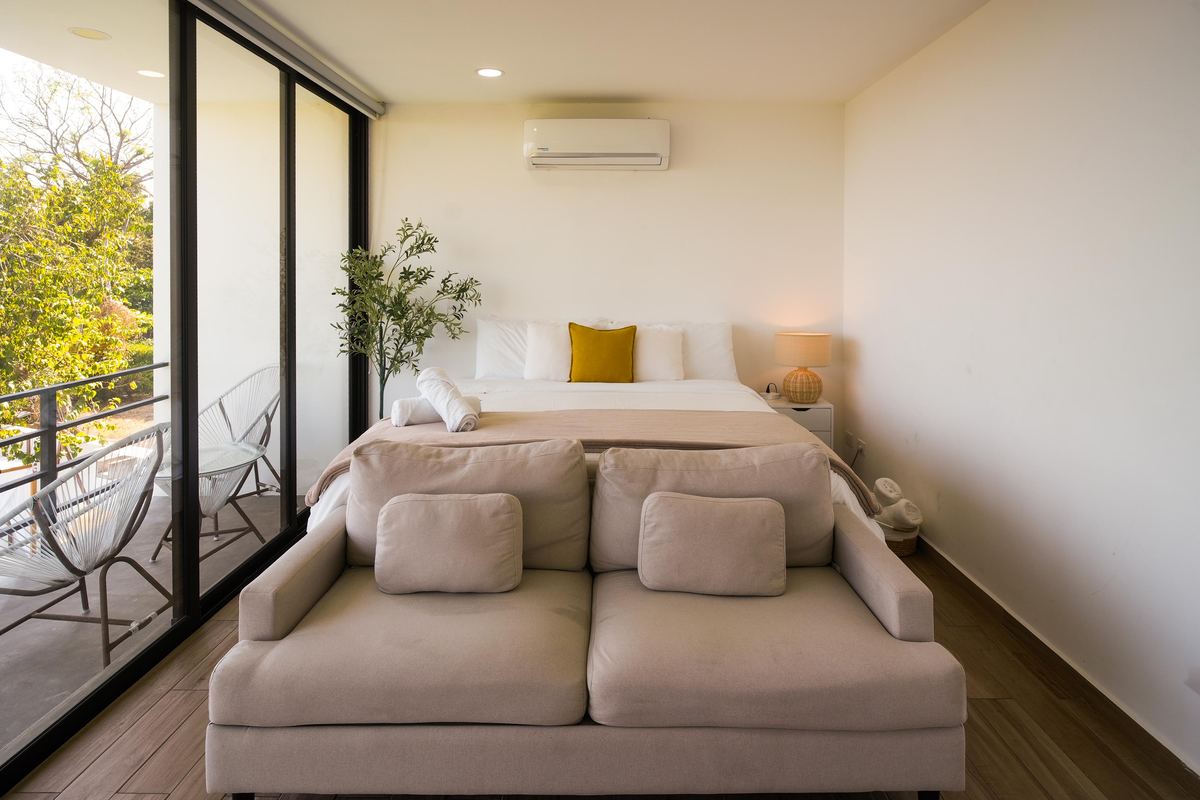 Bright bedroom with seating area and balcony