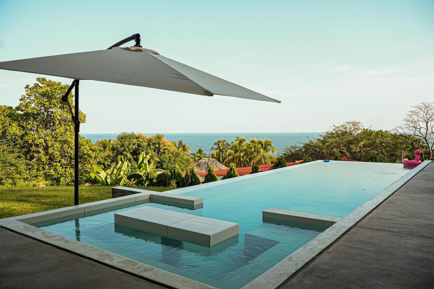 Infinity pool with jungle and ocean views